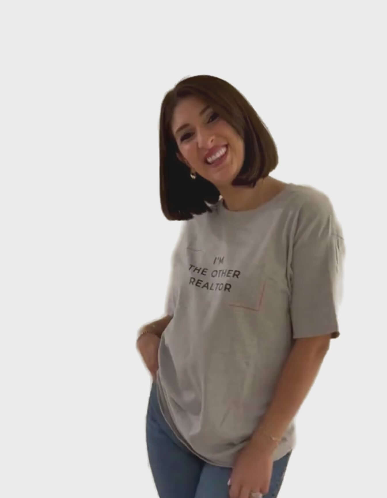 Woman smiling while wearing the I'm The Other Realtor T-Shirt in a casual pose.